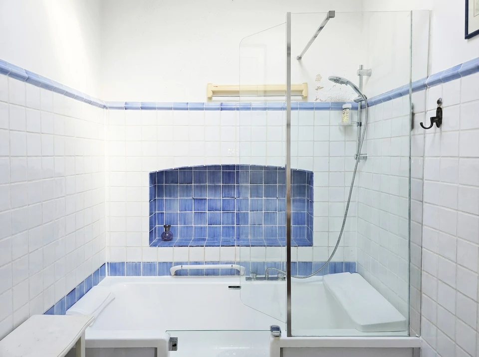 Salle de bain moderne avec douche à l'italienne, WC et vasque encastrée dans plan de travail noir
